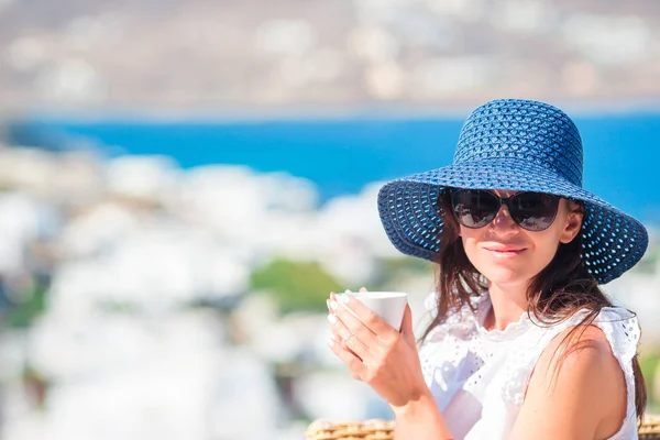 Retrato de joven turista en el desayuno en la cafetería al aire libre con una vista increíble del antiguo pueblo griego — Foto de Stock