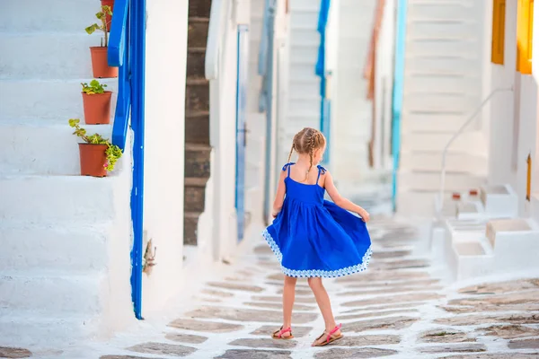 Beautiful girl at street of typical greek traditional village with amazing steps and white walls on Mykonos — Stock Photo, Image