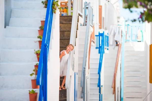 Vacker flicka på gatan av typisk grekisk traditionell by med fantastiska steg och vita väggar på Mykonos — Stockfoto
