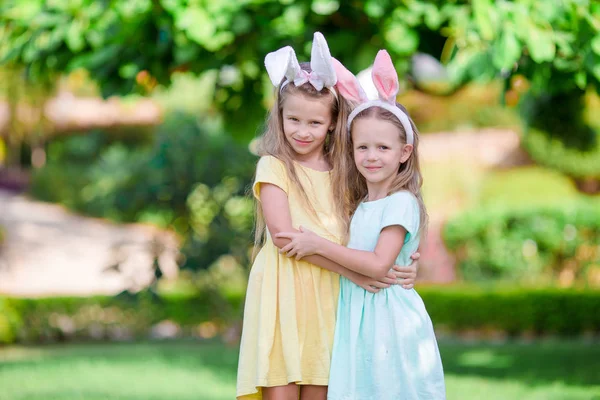 Girls wearing bunny ears on Easter day outdoors. Kids enjoy easter holiday — Stock Photo, Image