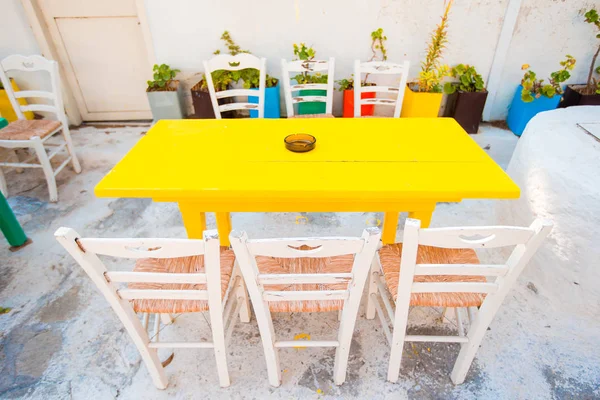 Empty openair cafe with colorful tables at greek old village — Stock Photo, Image