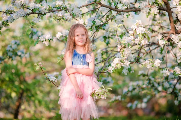 Schattig meisje in bloeiende apple tree tuin genieten van de warme dag — Stockfoto