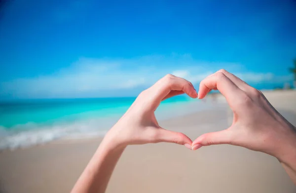 Hands in the shape of heart on the background of the Caribbean Sea — Stock Photo, Image