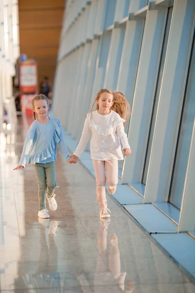 Little kids together in airport waiting for boarding indoors — Stock Photo, Image