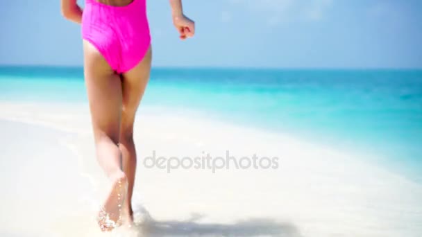 Adorable little girl at beach having a lot of fun in shallow water — Stock Video