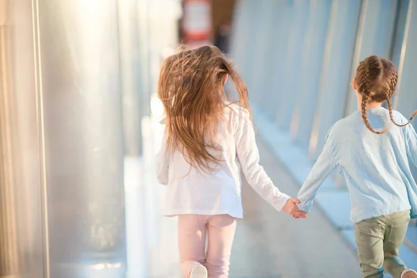 Little girls in airport while wait for their flight — Stock Photo, Image