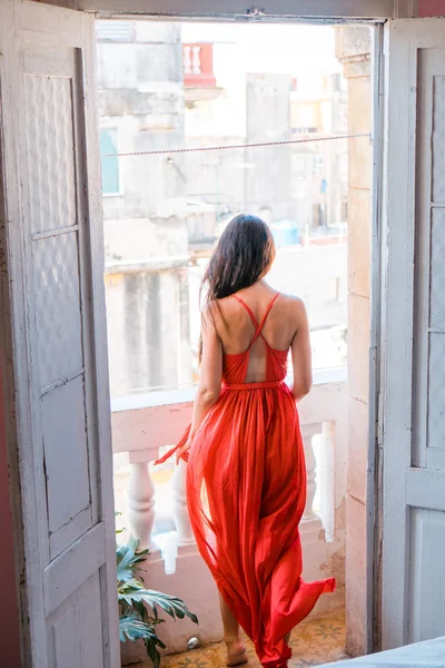 Joven mujer atractiva en vestido rojo en viejo balcón en apartamento en La Habana —  Fotos de Stock