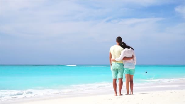 Happy family on the beach. Young lovers enjoy their honeymoon. SLOW MOTION VIDEO.