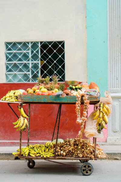 A small cart of fruits and vegetables on the street of Old Havana area for sale.