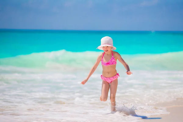 Urocza dziewczynka na plaży bawiąca się na płytkiej wodzie — Zdjęcie stockowe