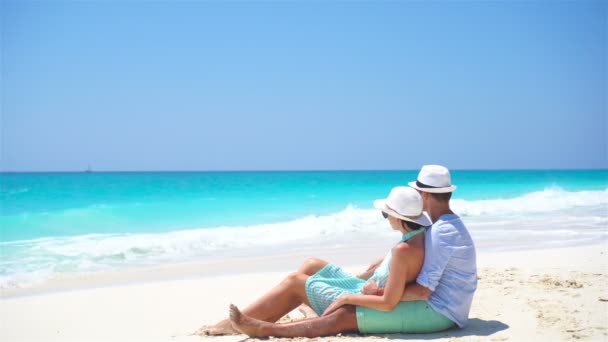 Young couple on white beach during summer vacation. Happy lovers enjoy their honeymoon.