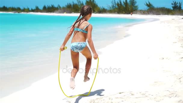 Active little girl at beach having a lot of fun. Sporty kid on the seashore in slow motion — Stock Video