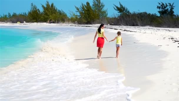 Kleines entzückendes Mädchen und junge Mutter am tropischen Strand. Eine zweiköpfige Familie hat in den Sommerferien viel Spaß. Zeitlupe — Stockvideo