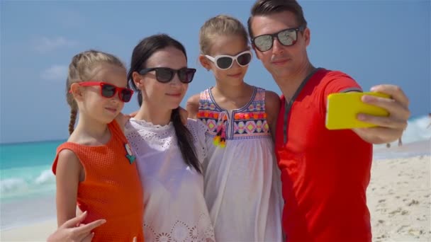 Young beautiful family taking selfie portrait on the beach — Stock Video