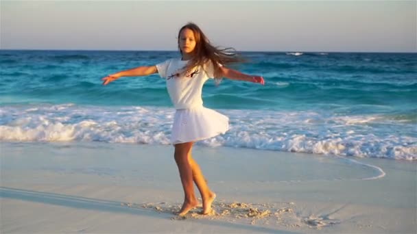 Αξιολάτρευτο μικρό κορίτσι στην παραλία έχουν πολλή διασκέδαση. Αργή κίνηση — Αρχείο Βίντεο