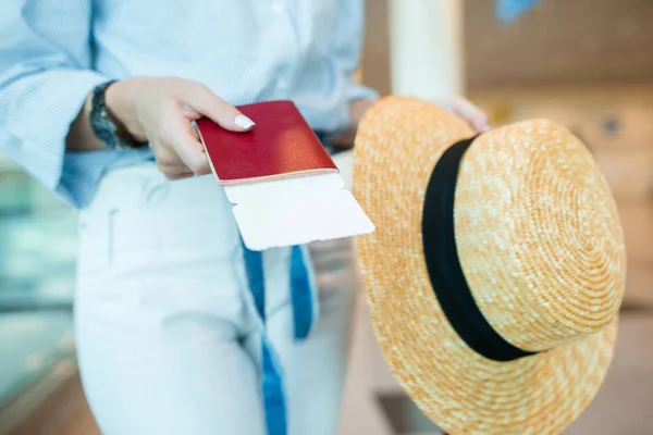 Close-up of passports and boarding pass in female hands at airport — Stock Photo, Image