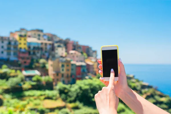 Close-up van smartphone achtergrond van oude Italiaanse dorp in Cinque Terre. Man met mobiele smartphone. — Stockfoto