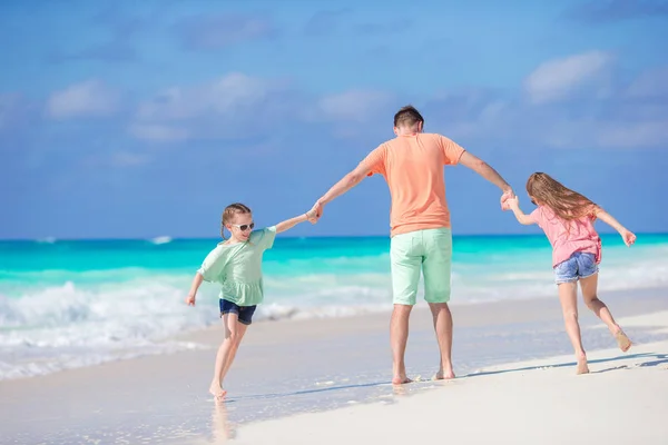 Family on white tropical beach have a lot of fun. Father and kids enjoy holidays on the seashore — Stock Photo, Image