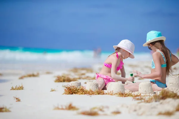 Adorable little kids play with sand on the white beach — Stock Photo, Image
