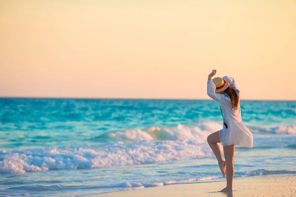 Νεαρή όμορφη γυναίκα στην τροπική παραλία στο ηλιοβασίλεμα. Ευτυχισμένος κορίτσι στο φόρεμα το βράδυ στην παραλία — Φωτογραφία Αρχείου