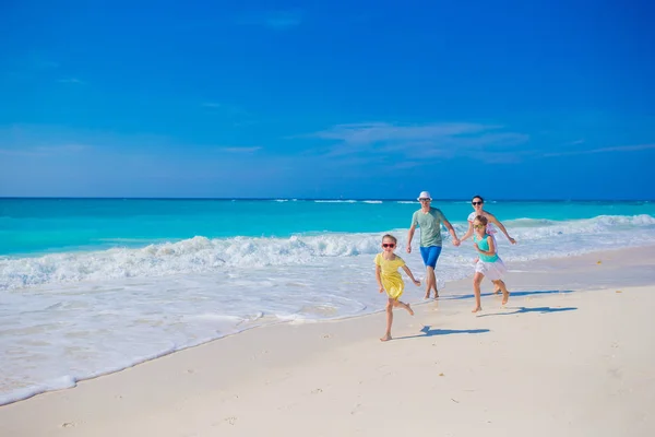 Family on white tropical beach have a lot of fun. Father and kids enjoy holidays on the seashore — Stock Photo, Image