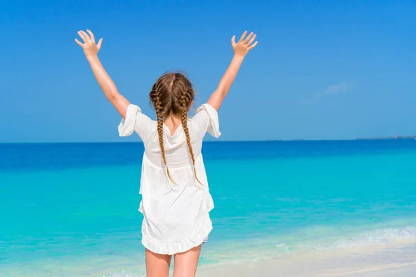 Amazing little girl at beach having a lot of fun on summer vacation. Adorable kid jumping on the seashore — Stock Photo, Image