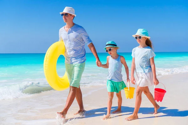 Aile baba ve çocuklar plaj oyuncakları ile Karayip adada beyaz tropik Sahilde yürüyüş — Stok fotoğraf
