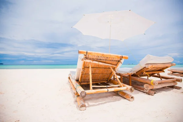 Strandliegen und Sonnenschirme am exotischen tropischen weißen Sandstrand — Stockfoto