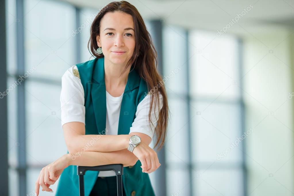 Portrait of young woman an airport lounge waiting for boarding