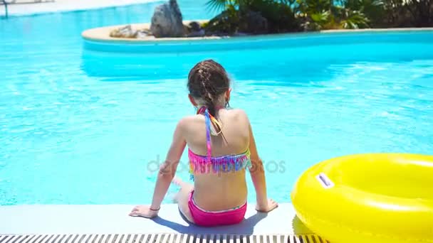 Bambina con cerchio di gomma gonfiabile in piscina — Video Stock