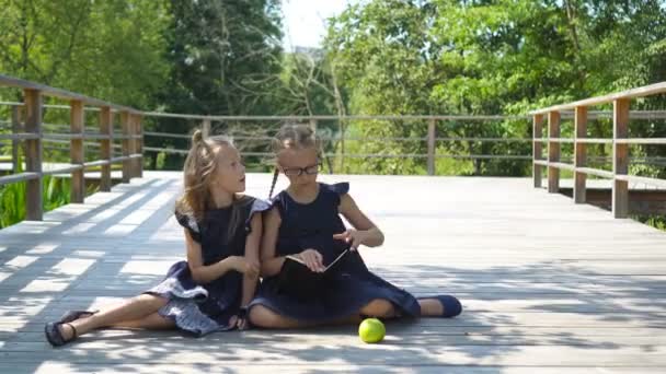 Adorable little school girls with notes and pencils outdoor. Back to school. — Stock Video
