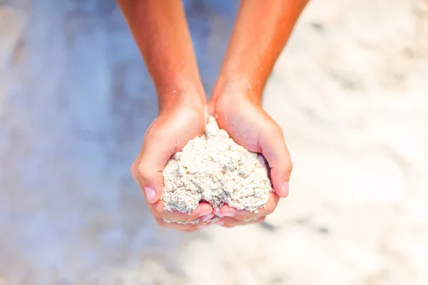 Closeup male hands holding white tropical beach form heart shape background the sea — Stock Photo, Image