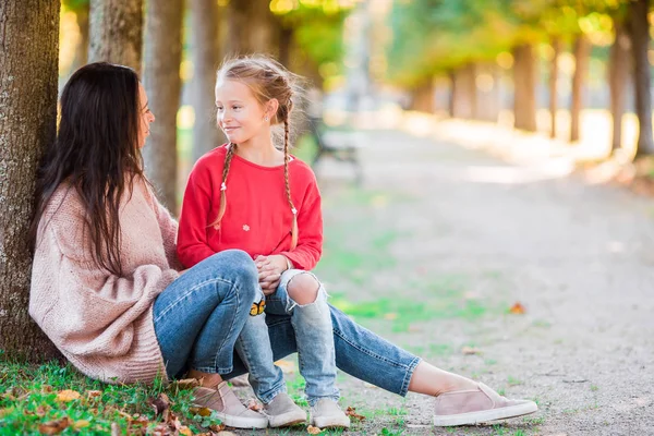 Family of mother and little kid outdoors in park at autumn day — Stock Photo, Image