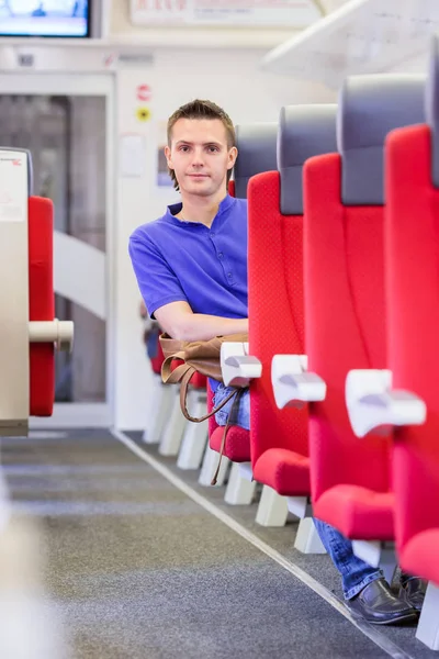 Young man traveling by train — Stock Photo, Image