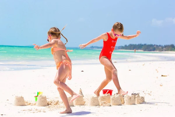Очаровательные маленькие девочки на летних каникулах. Дети играют с пляжными игрушками на белом пляже — стоковое фото