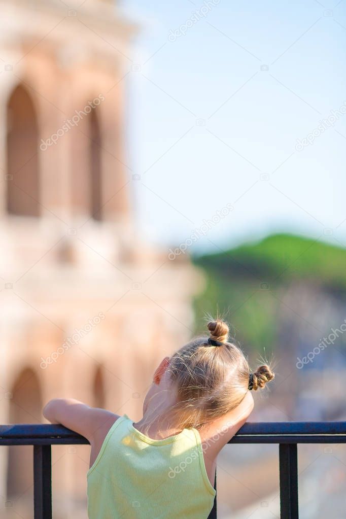 Adorable little girl in front of Colosseum in Rome, Italy. Kid spending childhood in Europe