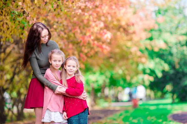 Family of mom and little kids at autumn day outdoor. Beautiful happy family in fall on sunny day — Stock Photo, Image