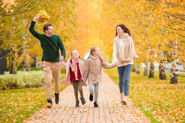 Beautiful happy family of four in autumn day outdoors — Stock Photo, Image