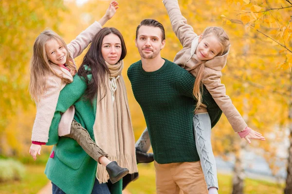 Beautiful happy family of four in autumn day outdoors — Stock Photo, Image