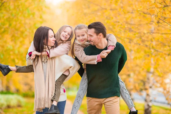 Beautiful happy family of four in autumn day outdoors — Stock Photo, Image