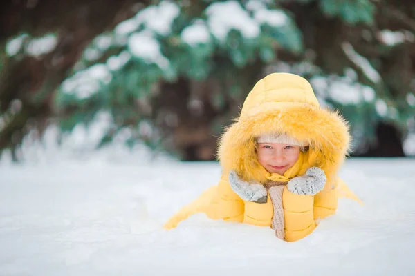 Portrait of little adorable girl with beautiful green eyes in snow sunny winter day — Stock Photo, Image