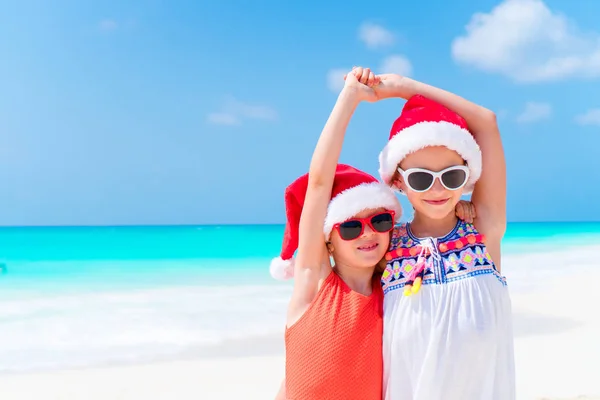 Rozkošné malé děti v Santa hat během vánoční dovolenou na pláži. Nový rok na pláži — Stock fotografie