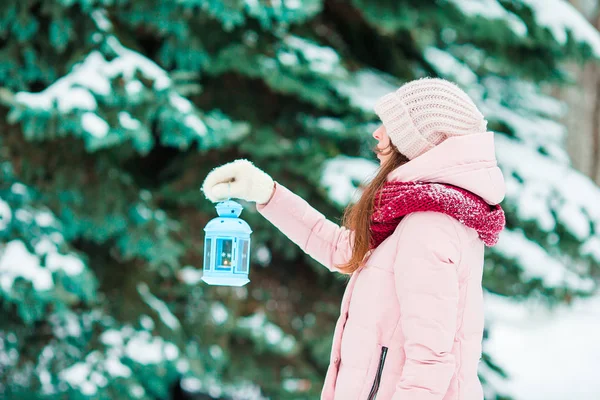 Winter day. Woman holding Christmas lantern outdoors on beautiful winter snow day — Stock Photo, Image