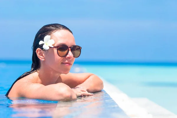 Joven hermosa mujer disfrutando de vacaciones de verano en la piscina de lujo al aire libre — Foto de Stock