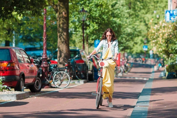 Happy young woman on bike in Amsterdam — Stock Photo, Image