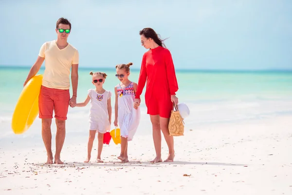 Familia de cuatro en vacaciones de playa con anillo inflable y cubos de juguete —  Fotos de Stock