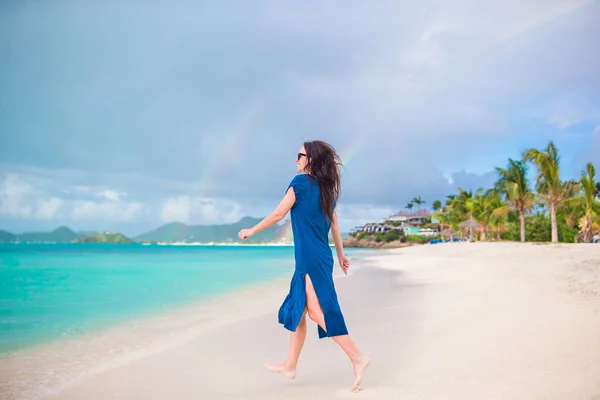 Joven hermosa mujer divirtiéndose en la orilla del mar tropical. Chica feliz caminando en la playa tropical de arena blanca — Foto de Stock