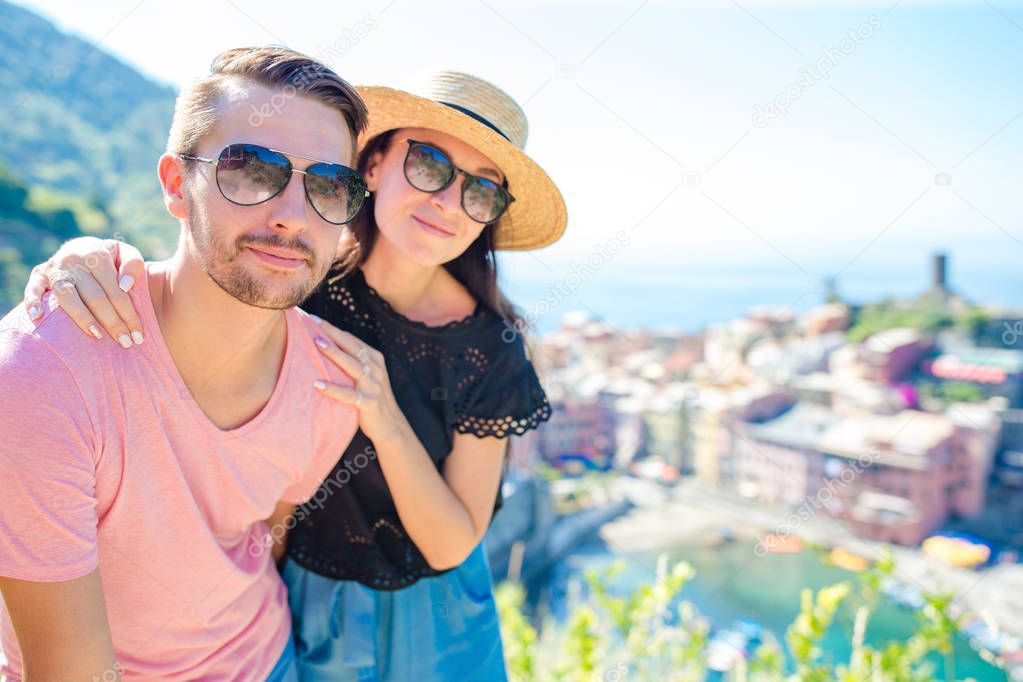 Young couple with view of the old coastal village in Cinque Terre national park, Liguria, Italy ,Europe