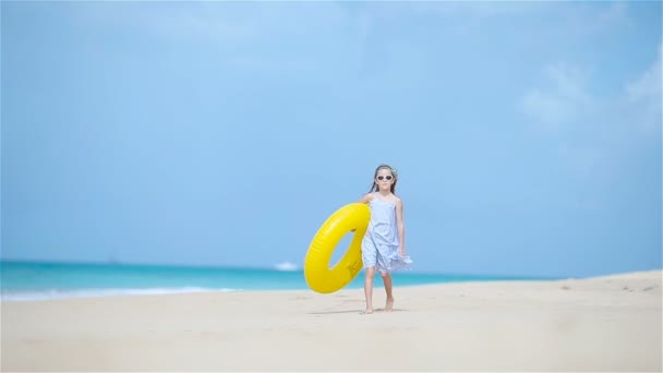 Adorable dziewczyna z nadmuchiwane gumowe koła na białej plaży gotowy do pływania — Wideo stockowe