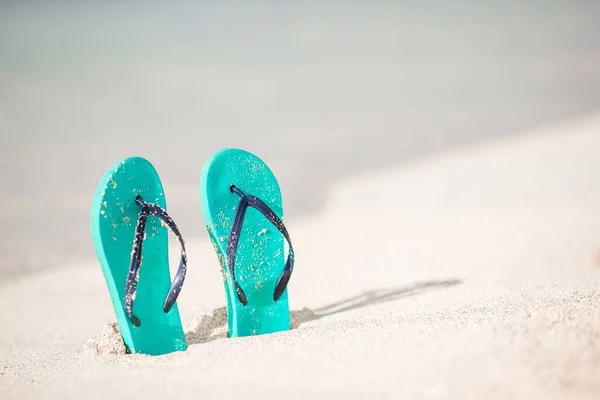 Summer mint flip flops with sunglasses on white beach — Stock Photo, Image
